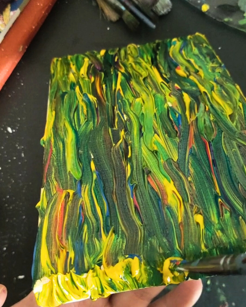 Creating a textured background for a painting involves applying layers of Phthalo Green mixed with a texture medium using vertical strokes with a palette knife. Yellow highlights are added while the paint is wet to create depth, and varying pressure introduces further texture. A water spritzer is used for organic effects, resulting in a rich, dimensional backdrop that enhances the overall composition.