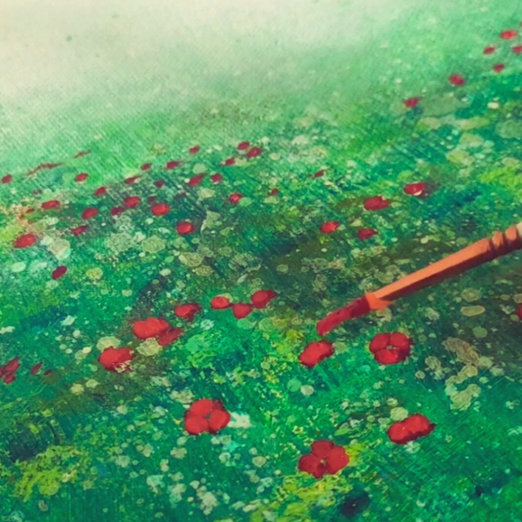 a person is painting on a canvas with a brush