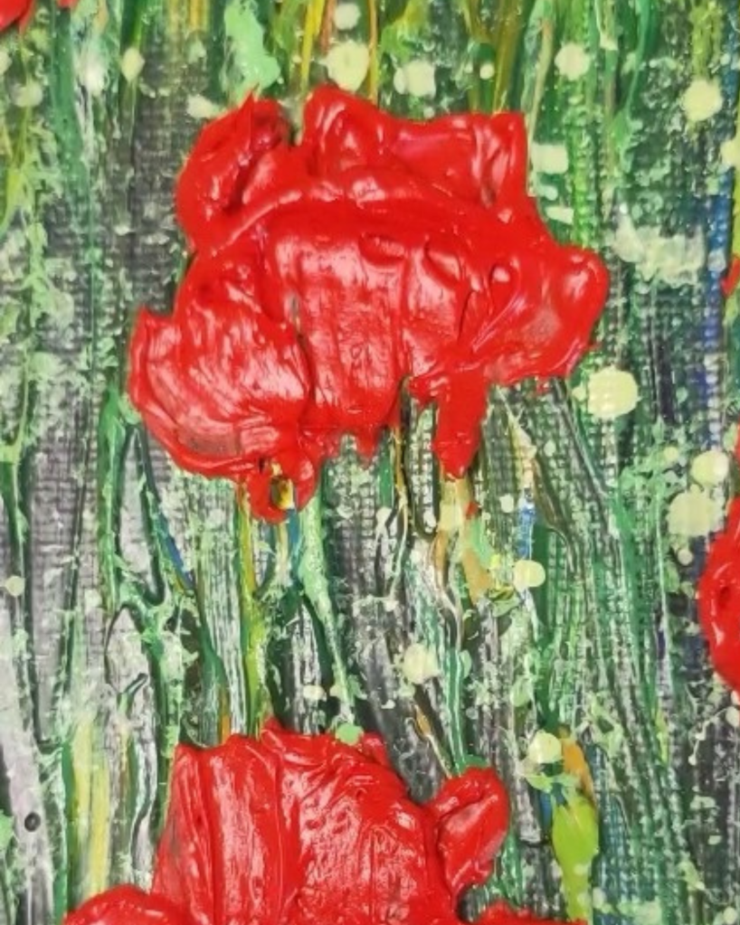 A close-up image of a textured poppy painting highlighting the rain droplet effect. The painting features vibrant red poppy petals with raised, glossy droplets created using clear texture medium mixed with white. The droplets vary in size, with larger ones placed strategically on the petals and smaller ones scattered across the background, adding a natural, fresh appearance. The texture and shine of the droplets contrast beautifully against the matte finish of the petals, enhancing the painting's dimensional quality.