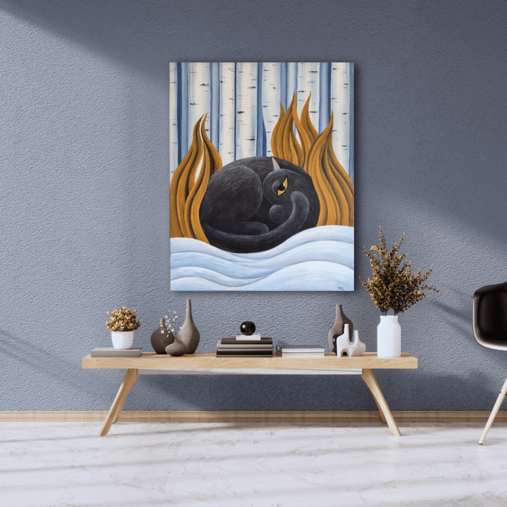 Painting titled 'Winter's Embrace' featuring a black cat curled up among birch trees with swirling snow, displayed in a modern living space. The artwork uses soft blues, warm browns, and whites to create a serene winter scene.
