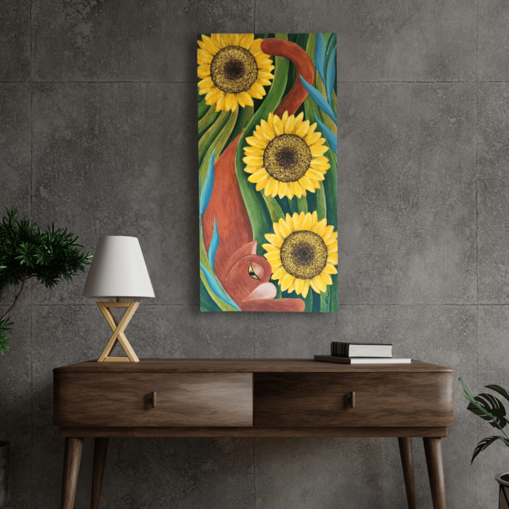 Painting titled 'Sunlit Sanctuary' featuring a ginger cat nestled among vibrant sunflowers and lush green foliage, displayed in a modern living space. The artwork uses bold colors and a vertical composition to create a lively visual impact.